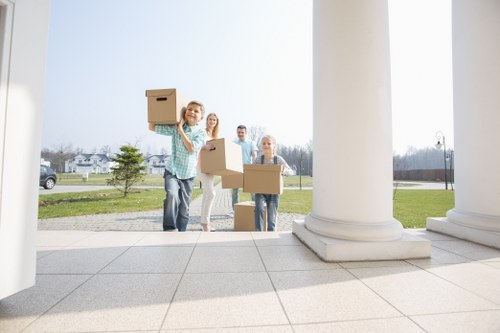 Professional movers carrying items down stairs in a flat removal