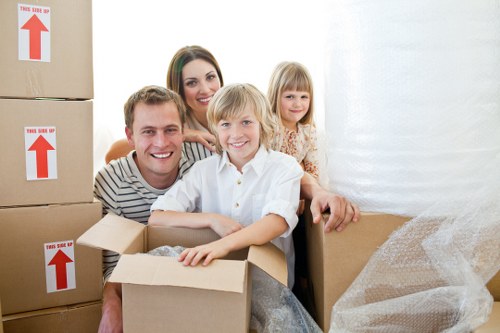 Professional movers carrying furniture outside a Chelsea property