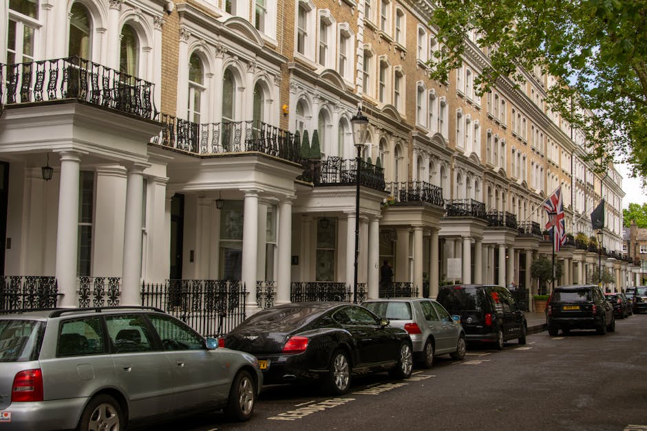 A multi-storey residential building located on Kings Road in Chelsea SW3, featuring a brown brick facade, numerous white-framed windows, and a series of dormer windows on the sloped roof. The building